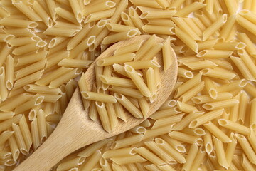 Pasta background with wooden spoon.
