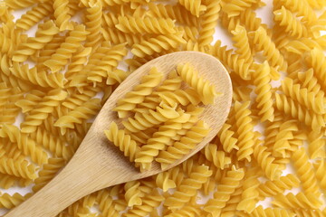 Pasta background with wooden spoon.