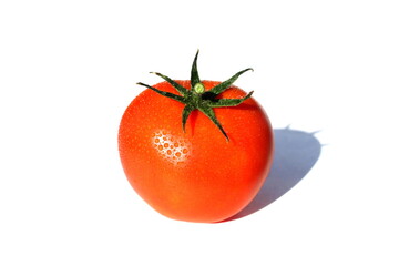 Red ripe tomato with drops of water is on a white isolated background.