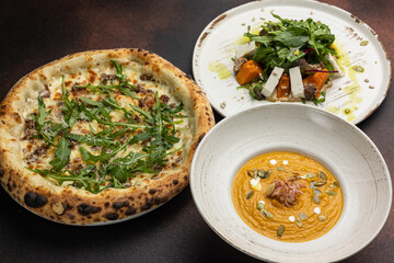 delicious pizza, soup and salad on the table