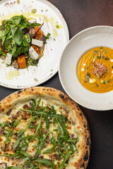 delicious pizza, soup and salad on the table