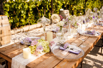Wedding decorations. Set wedding table with silver plates, purple napkins, decorative fresh and...
