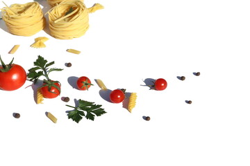 Three spaghetti in the form of a nest with vegetables and spices lie on a white background.