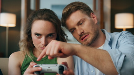 Skilful gamer teaching play woman at videogame pov. Focused lady holding gamepad