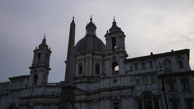 Low-angle view of 17th-century church Sant'Agnese in Agone - SantAgnese in Piazza Navona, one of main urban spaces in historic centre, on background of sky, no people. Shooting in slow motion.
