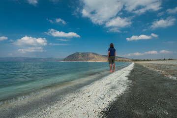A man by the famous Salda Lake. Tourist visiting the turquoise coloured lake.  Turkey is known as the Maldives.   Burdur province