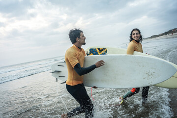 With excitement, friends gear up to ride the wave. They prepare their boards, don wetsuits, and...