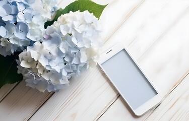 beautiful blue hydrangea flowers and phone on light wooden table for freelancing business card decor