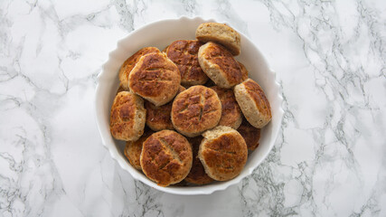 shortbread in a white bowl on white marble table  top view