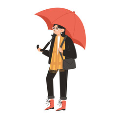 A young woman, warmly dressed, holds an umbrella