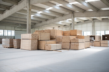 A vast warehouse in the forestry industry, showcasing a plethora of wooden products, including boards and various timber items neatly organized in storage