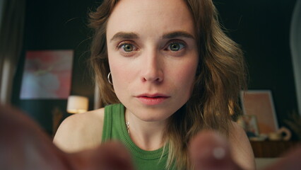 Attentive girl reading device home web camera view. Surprised lady face amazed