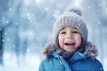 A little boy plays in a snowy winter forest in winter clothes.