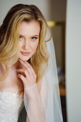 a beautiful, delicate and sexy blonde bride in a veil. Wedding services.