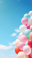 Fototapeta na wymiar Pastel colors balloons bunch in blue sunny sky background with copy space