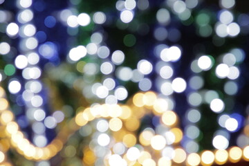 Abstract blurred background in bokeh. White lights of blinking garland in blur