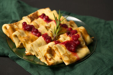 Pancakes stuffed with cheese with cranberry sauce
