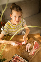 A girl prepares a traditional Christmas dish 
