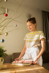 A girl prepares a traditional Christmas dish 