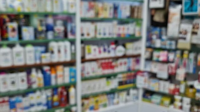 Blurred view of pharmacy stocked shelves. Healthcare and cosmetics industry defocused background
