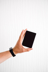 Man holding card in hand. Male shopper holds a credit card in his hand, cashless transactions and mobile payments. Banking with a credit card