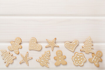 Cute homemade Christmas cookies on wooden background,top view