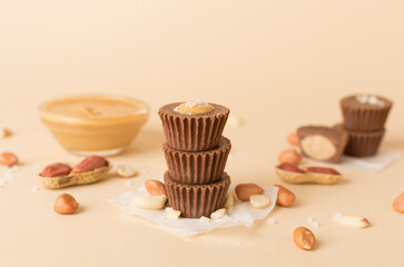 Tasty chocolate peanut butter cups on color background