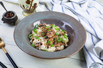 Italian cuisine - risotto with mushrooms. Cooked arborio rice with parmesan cheese and mushrooms
