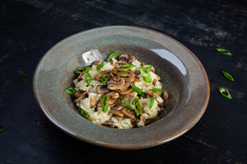 Italian cuisine - risotto with mushrooms. Cooked arborio rice with parmesan cheese and mushrooms