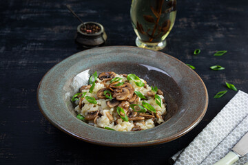 Italian cuisine - risotto with mushrooms. Cooked arborio rice with parmesan cheese and mushrooms