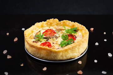 Delicious quiche with chicken meet, mushrooms, tomatoes and herbs