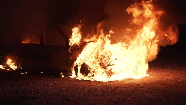 Burning car automobile on fire at night. Transport explosion. High quality 4k footage