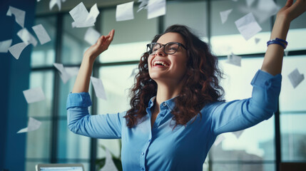 Moment of triumph, showing a joyful woman in an office setting, tossing papers into the air with a bright smile
