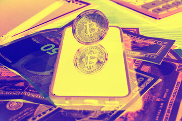 Bitcoin coin in neon color. Coin and display in glass. Light negative film. Money and coins under ultraviolet light.