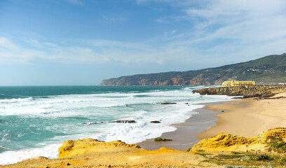 Scenic view of Praia do Guincho beach near Cascais, Portugal. Famous spot on the Portuguese coast of the Atlantic Ocean for surfing, windsurfing and kitesurfing