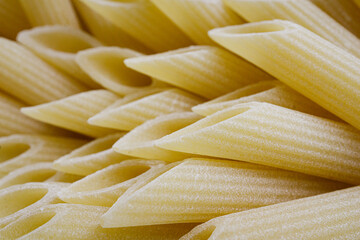 Close up view of uncooked penne rigate pasta 