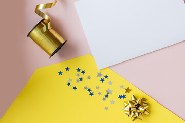 DIY Christmas Design. Decorative Card, Kraft Paper Envelopes, Greeting Cards on colorful Background. Holidays Mockup. composition with scissors, ribbon and stars, Top view, write message.