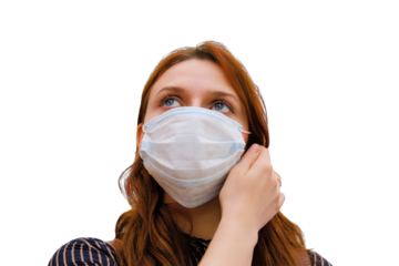 A young woman is considering whether to remove the medical mask after the end of the quarantine due to the coronavirus, isolated on a white background. Portrait of a woman after the flu virus