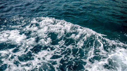 View from the ship on splashing ocean waves on cold stormy day