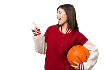 Young Russian woman playing basketball over isolated chroma key background pointing finger to the side and presenting a product