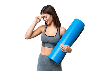 Young sport woman going to yoga classes while holding a mat over isolated chroma key background...