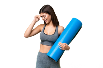 Young sport woman going to yoga classes while holding a mat over isolated chroma key background laughing