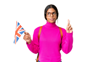 Young African American woman holding an United Kingdom flag over isolated chroma key background with fingers crossing and wishing the best