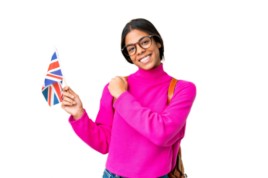 Young African American woman holding an United Kingdom flag over isolated chroma key background celebrating a victory