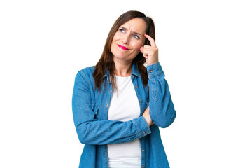 Middle age woman over isolated chroma key background having doubts and with confuse face expression