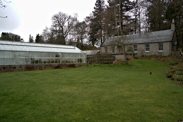 Fototapeta na wymiar Castle Green house surrounded by lush green Scottish grass 