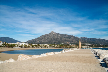 an image the beaches and mountain ranges that surround Puerto Banus.