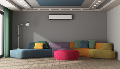 Large multicolored sofa in a modern room with gray wall and air conditioner