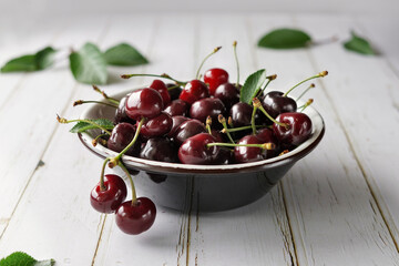 plate with burgundy cherries, minimalism, close-up, no people