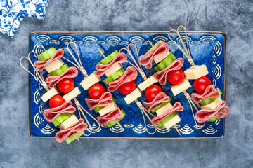 Mini Greek deli kebabs with salami, cheese, cherry tomatos and cucumber - party finger food